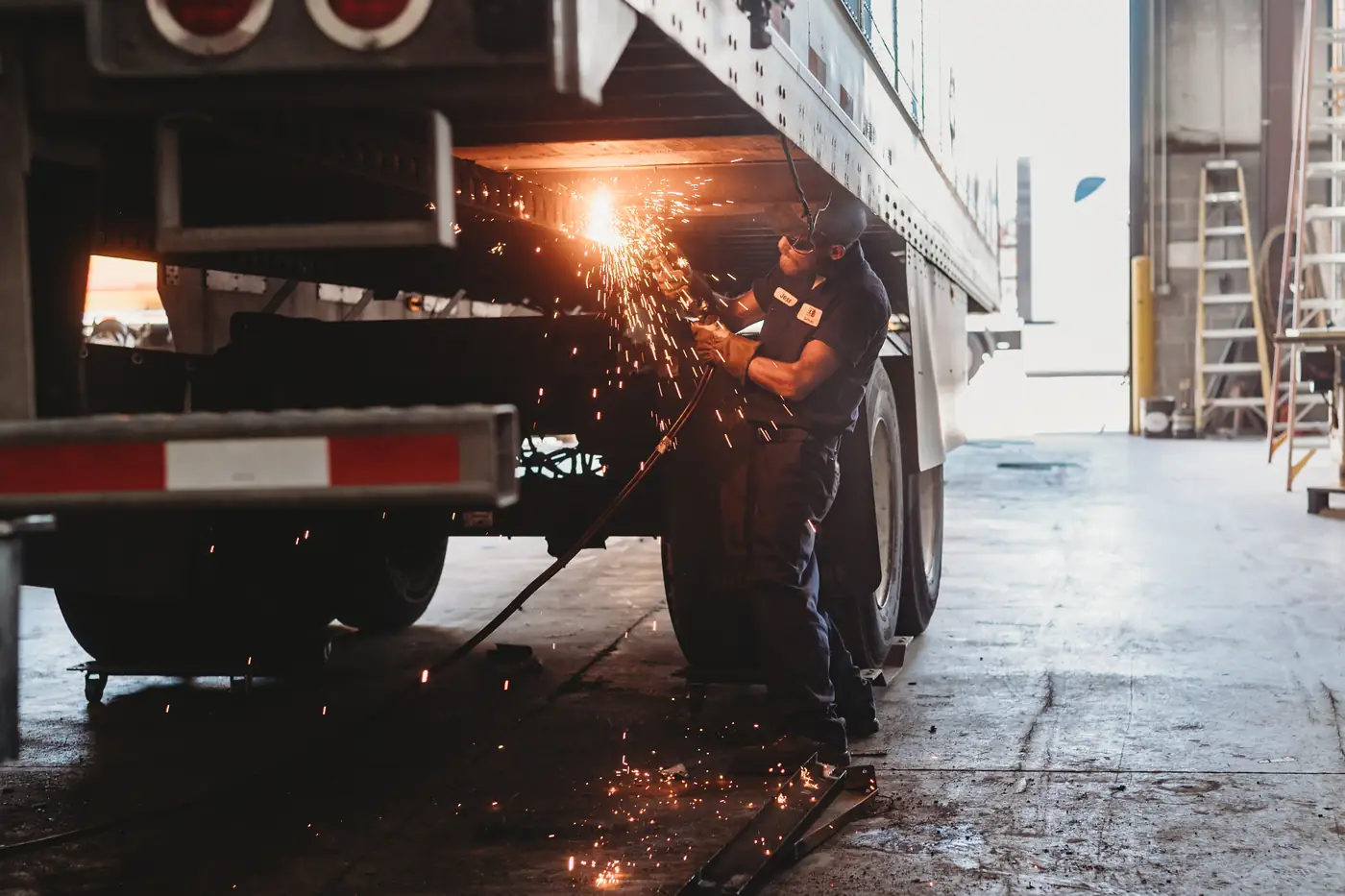 Grinding sparks under a trailer at Knox Trailers